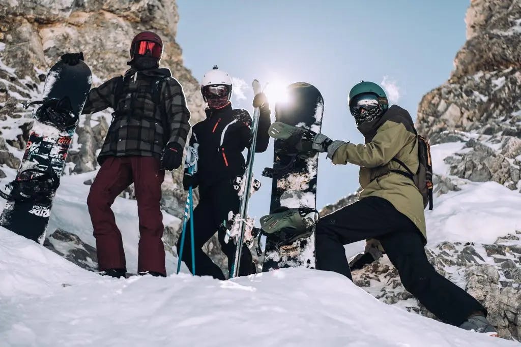 Three friends snowboarding Tignes